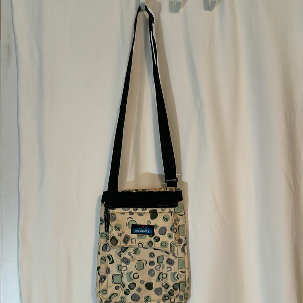 KAVU cross bodied purse. Made of canvas. 2 extra pockets on front. One in back.